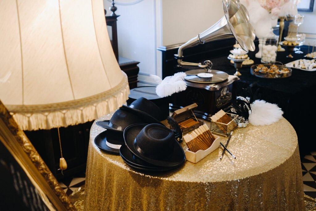 An old retro gramophone, hats and cigars are on the table